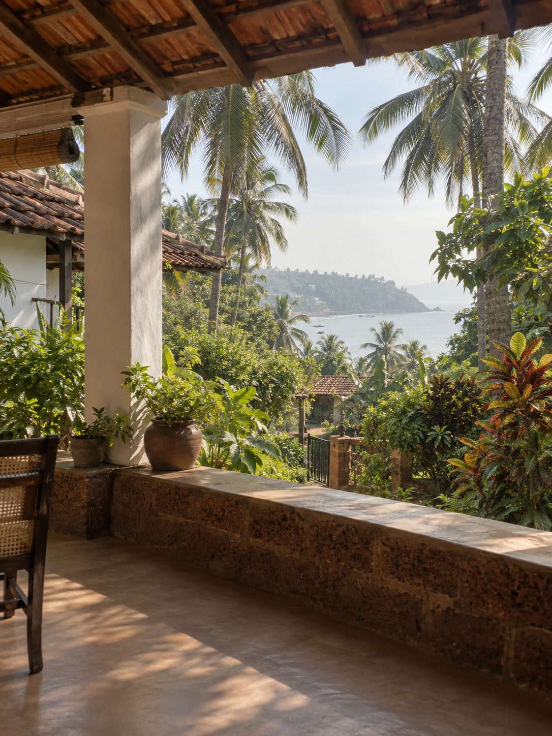 Peellagoda terrace at breakfast hour, looking toward Unawatuna bay through coconut palms